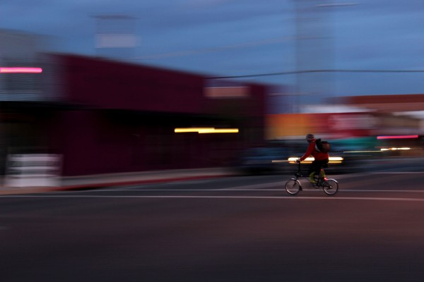 A cyclist bikes across the street in downtown Phoenix. Alexis Macklin for Downtown Devil